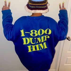 Blue long sleeve w/logo that say 1-800 Dump him
